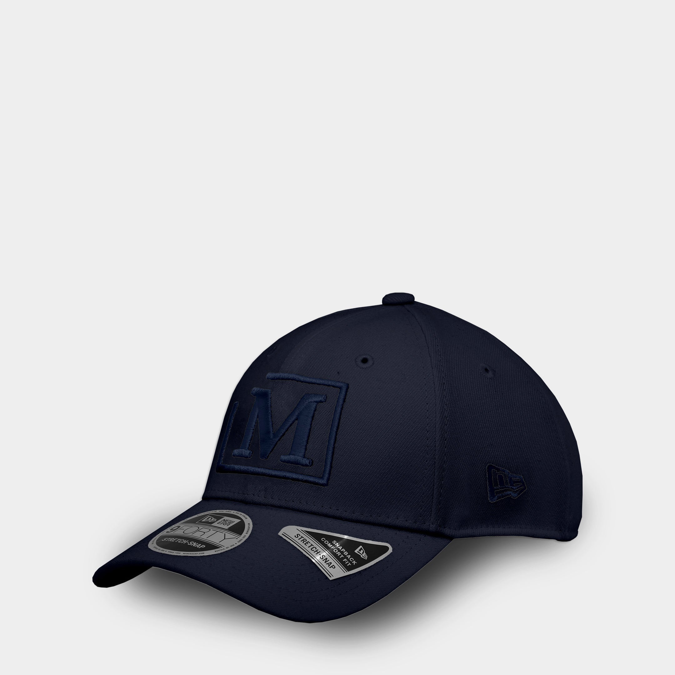 MDB Brand 9FORTY embroidered M snapback baseball cap, blue and navy, front angle view
