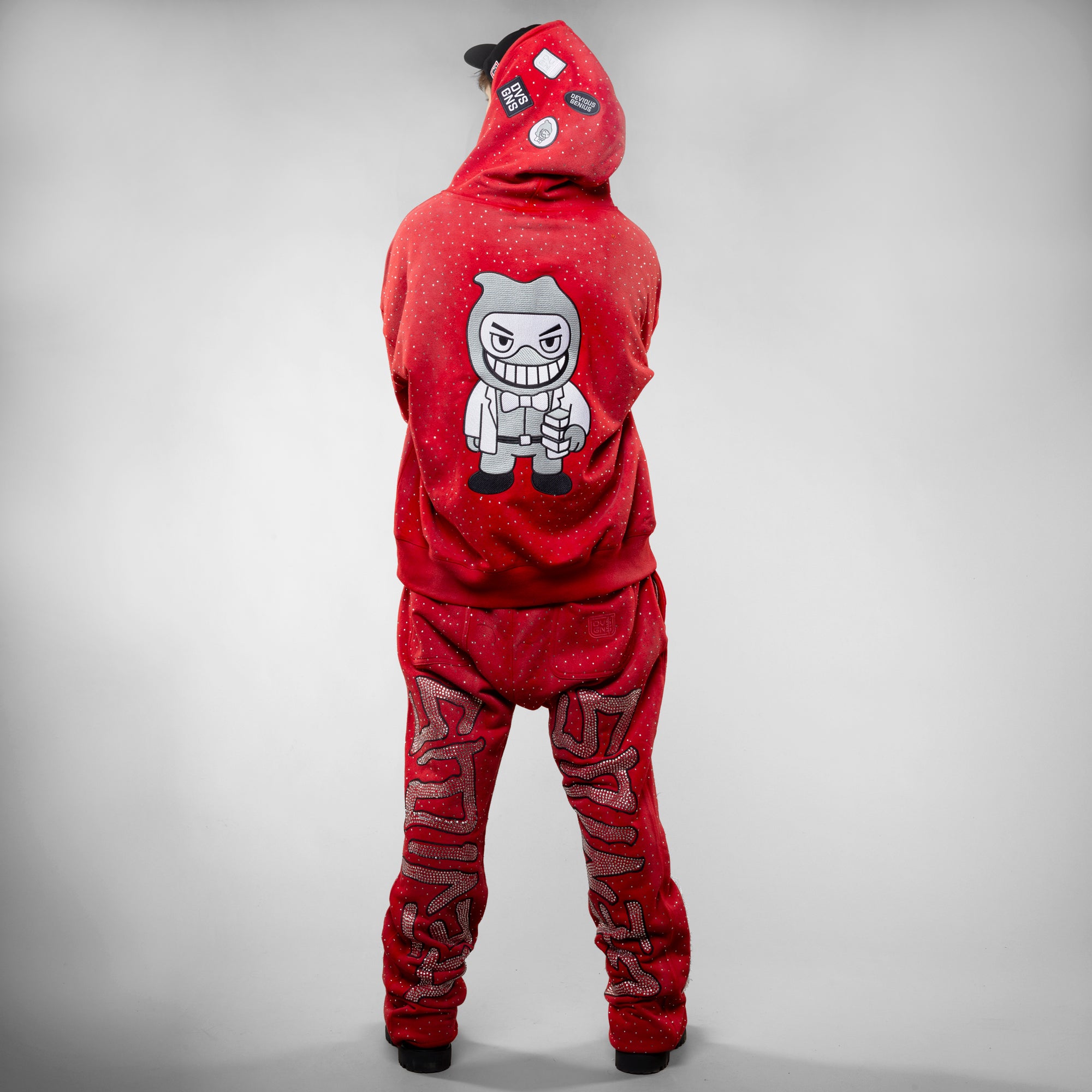 Red hoodie and pants with a graphic design on the back against a gray background