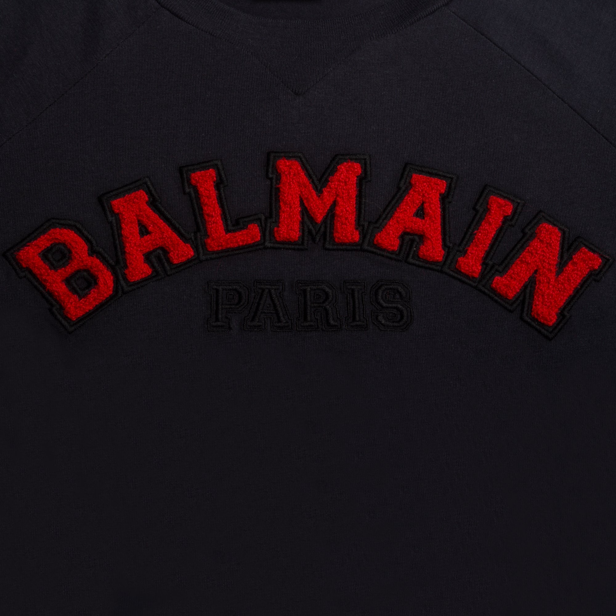 Black garment with red 'Balmain Paris' logo